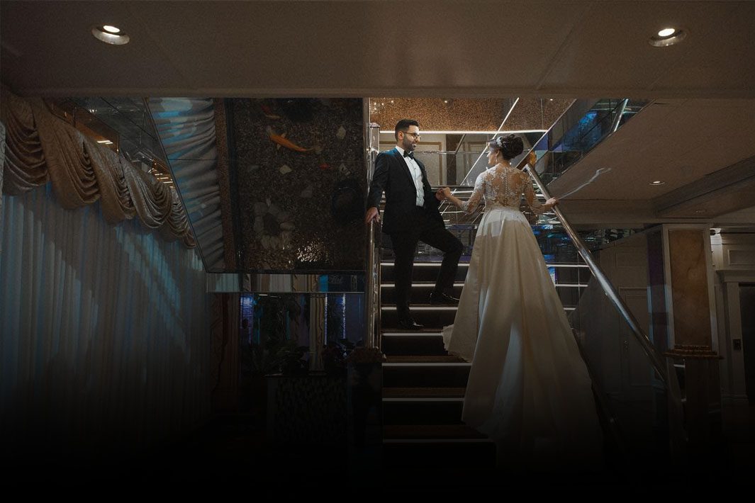 a bride and groom on a staircase