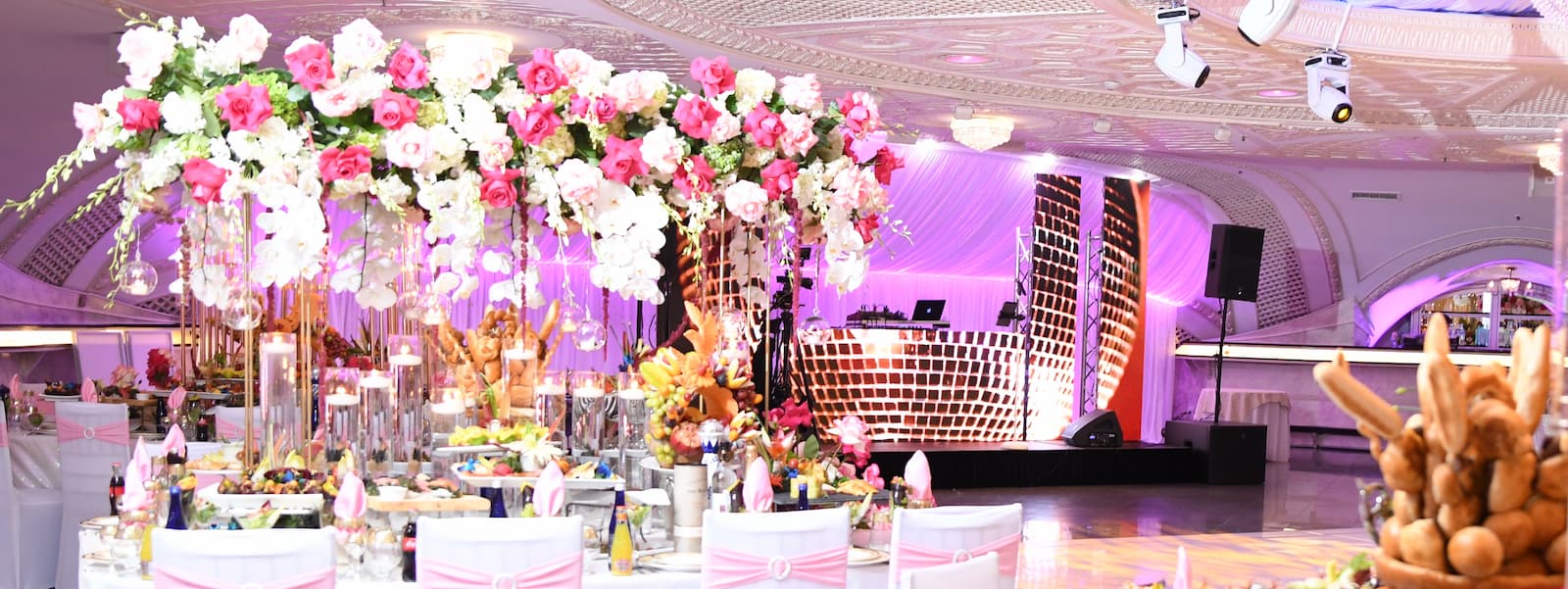 a wedding reception area, with flowers and food on tables