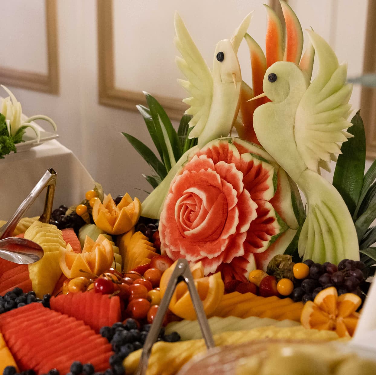 a fruit platter sculpture of a bird